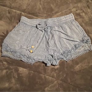 Light blue linen shorts with lace detail